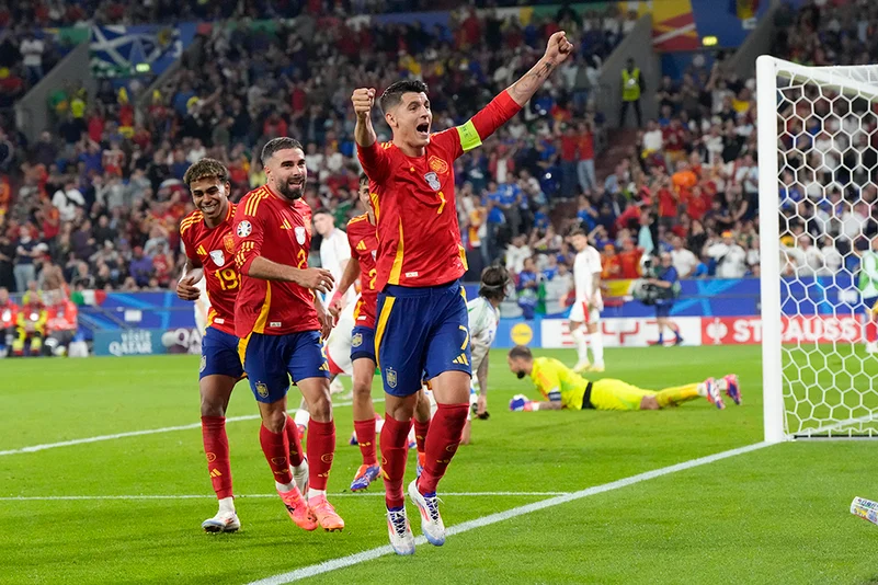 Spain players celebrate a own goal by Italys Riccardo Calafiori